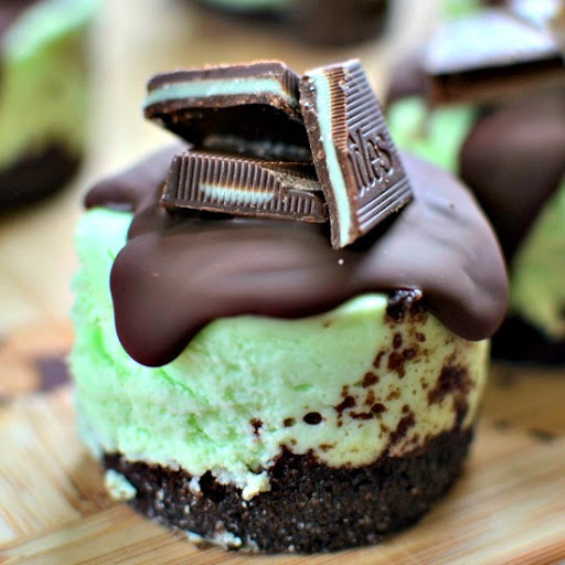 This delectable and adorable Andes Mint Mini Cheesecakes Recipe combines chocolate graham cracker crust with creamy mint flavored cheesecake all topped with a swirl of rich chocolate and Andes Mint Candies. 