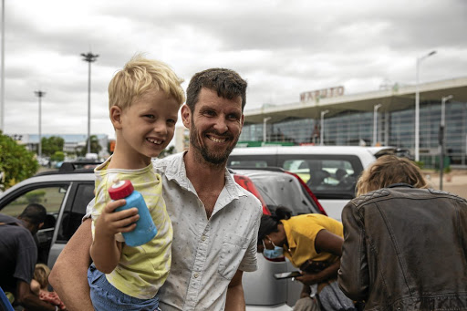 Zitamar News editor Tom Bowker and his son shortly before catching a flight for London from Maputo on February 16 after being ordered out of Mozambique.