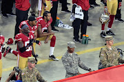 San Francisco 49ers quarterback Colin Kaepernick and teammate 49ers free safety Eric Reid (35) kneel during the playing of the national anthem before a NFL game against the Los Angeles Rams at Levi's Stadium.