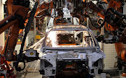 Robots weld a car body at the Audi/Volkswagen AG plant in Ingolstadt in 2010.