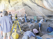 BONING UP OUR KNOWLEDGE: Archaeologists in the Cederberg Mountains, Western Cape, discovered a child's remains where there is a ledge in the pit. The white labels mark where artefacts have been removed from the pit walls