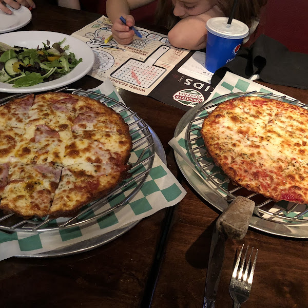 GF pizzas. Tasted great! Notice the green & white checkered paper marking all GF items.