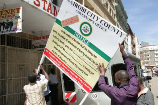 Nairobi county officers close a building on Dubois Road on February 24, 2018.