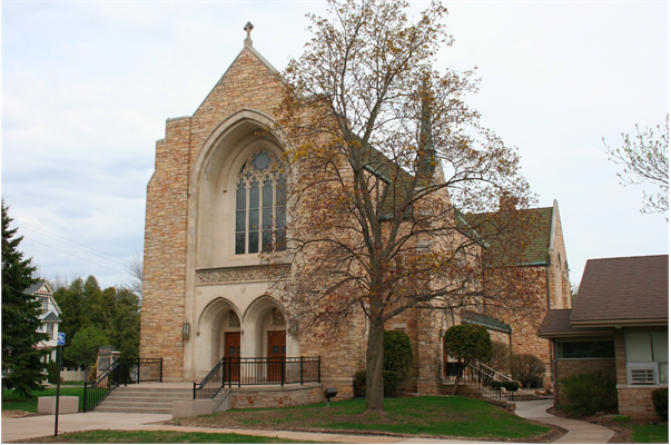 A church with a tree in front of itDescription automatically generated