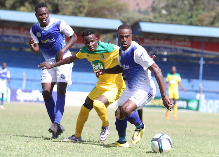 Sofapaka's Brian Mugonya (C) fights for the ball with Mathare's Cliff Nyakeya as Willis Obayi (L) comes to his rescue