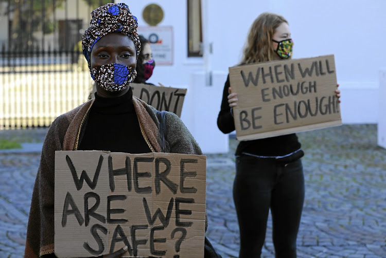 Protesters take a stand against SA’s unrelenting violence against women and girls, outside parliament in Cape Town.