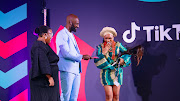 Dennis Ombachi aka The Roaming Chef presents the trophy for 'Lifestyle and Education Creator of the Year in Sub-Saharan Africa' to Iremide at the 2023 TikTok Top Creator Awards at Vodacom World in Johannesburg on February 9 2024.