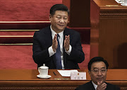 China's President Xi Jinping applauds after a vote on an amendment to the constitution during a session of the National People's Congress at The Great Hall Of The People on March 11, 2018 in Beijing, China.