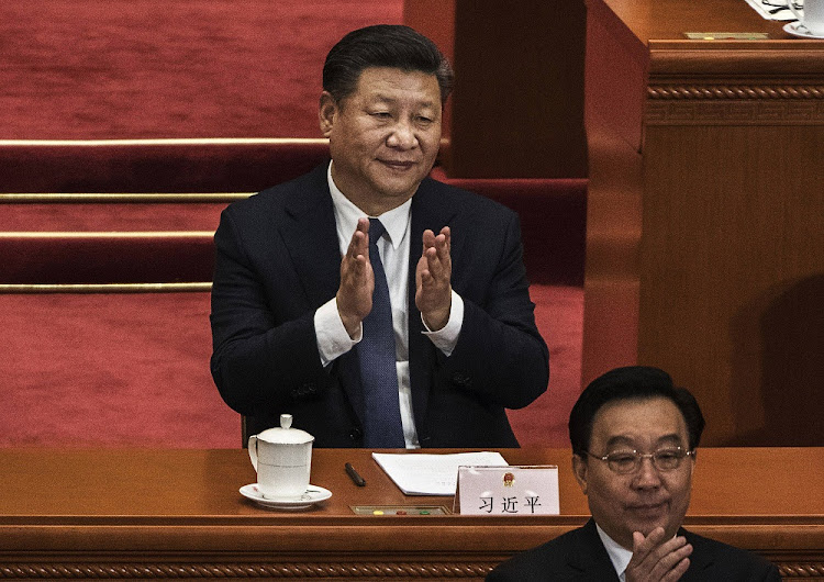 China's President Xi Jinping applauds after a vote on an amendment to the constitution during a session of the National People's Congress at The Great Hall Of The People on March 11, 2018 in Beijing, China.