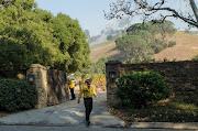 A firefighter walks out of a vineyard owned by Rupert Murdoch damaged by the Skirball fire near the Bel Air neighborhood on the west side of Los Angeles, California, U.S., December 6, 2017. 