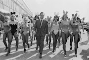 Playboy impresario Hugh Hefner (1926 - 2017) with a group of bunny girls at London Airport (now Heathrow), 25th June 1966. Hefner was flown in for the opening of the London Playboy Club. Hefner was born on April 9, 1926 in Chicago. He died at age 91 of cardiac arrest, respiratory failure, sepsis and an E. coli infection on September 27, 2017 in California. 