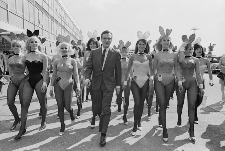 Playboy impresario Hugh Hefner (1926 - 2017) with a group of bunny girls at London Airport (now Heathrow), 25th June 1966. Hefner was flown in for the opening of the London Playboy Club. Hefner was born on April 9, 1926 in Chicago. He died at age 91 of cardiac arrest, respiratory failure, sepsis and an E. coli infection on September 27, 2017 in California.