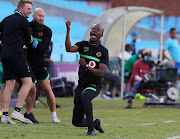 Kaizer Chiefs assistant coach Arthur Zwane (now caretaker coach, after the sacking of Gavin Hunt) punches the air in celebration. 