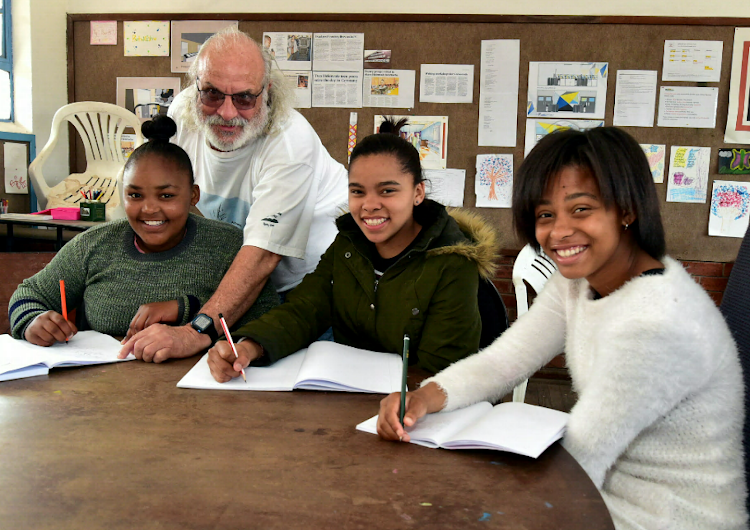 Helenvale poets, from left, Charmilla Bosman, Nathersia Fillis and Rahneisha Jackson with mentor and Helenvale Poets founder Brian Walter. The girls are part of a group of five young poets who will be going on a trip of a lifetime in January