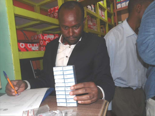 An official of the Anti-Counterfeit Agency assess items in a shop along Kirinyaga Road, Nairobi. /FILE