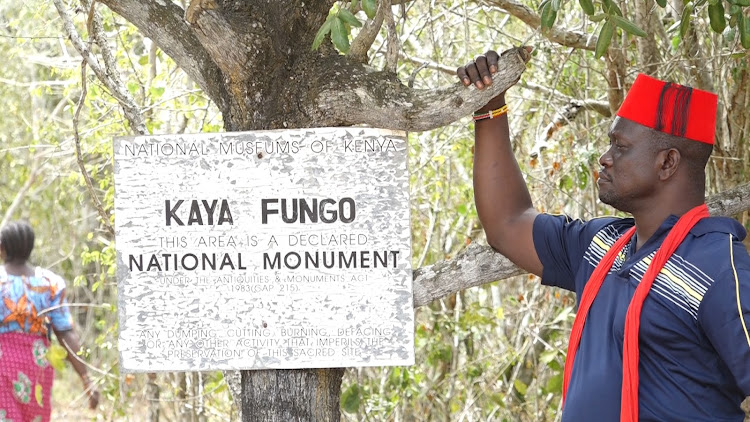 A kaya elder at the entrance of Kaya Fungo, one of the Mijikenda's sacred forests, in Kilifi county.