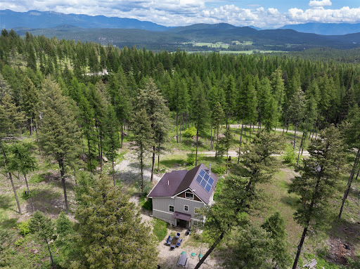 Luxury property for sale in Whitefish (United States) - House with solar panels, surrounded by trees