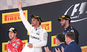 Ferrari's Sebastian Vettel, Mercedes' Lewis Hamilton and Red Bull's Daniel Ricciardo stand on the podium. REUTERS/Albert Gea