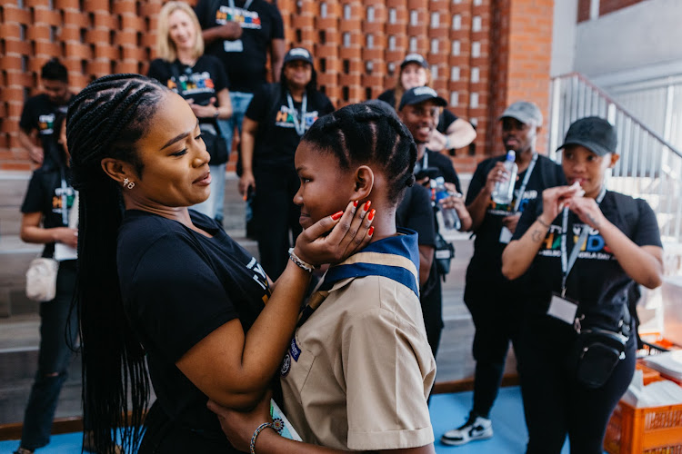 Nomzamo Mbatha shares heartfelt moment with a learner from JL Dube High School.