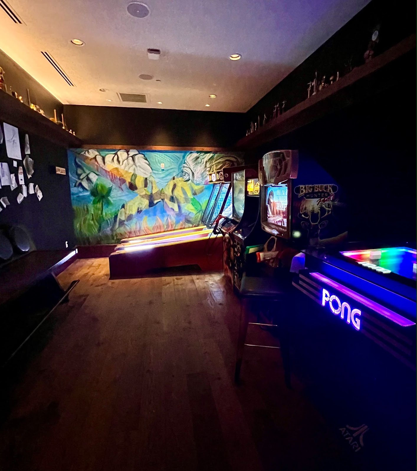 a room with a colorful wall and a arcade machine