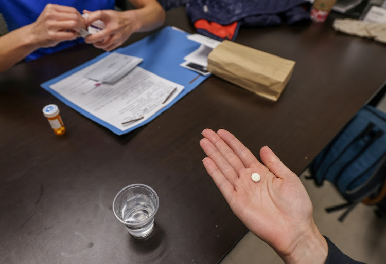 Dr. Shelly Tien hands a patient the initial abortion inducing medication at Trust Women clinic in Oklahoma City, US on December 6 2021. Picture: REUTERS/EVELYN HOCKSTEIN