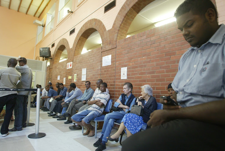 People resign themselves to queueing in a traffic licensing department.