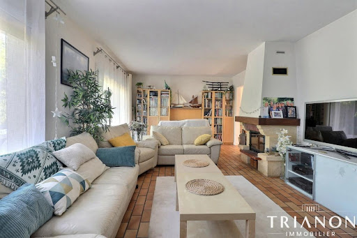 Living room with white sofa and coffee table in this luxury property for sale in Chambourcy ($955,507 - 198 m²)
