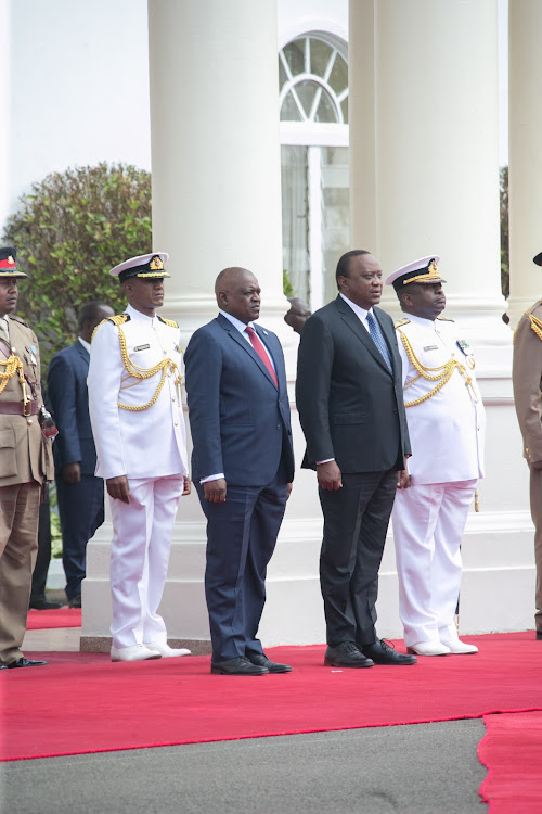 President Uhuru Kenyatta with the President of Botswana Mokgweetsi Eric Keabetswe Masisi when the Kenya Army mounted a Guard of Honour for the visiting Head of State at State House, Nairobi. Also present is Chief of Defence Forces General Samson Mwathethe.