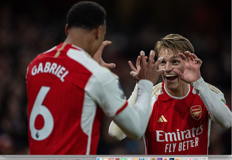 Arsenal's Gabriel Magalhaes (L) celebrates with teammate Martin Odegaard after scoring in a recent match against Newcastle United