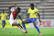 Gadiel Kamagi of Cape Town Spurs challenges Teboho Mokoena of Mamelodi Sundowns in the DStv Premiership match at Athlone Stadium on in Cape Town on Tuesday night.