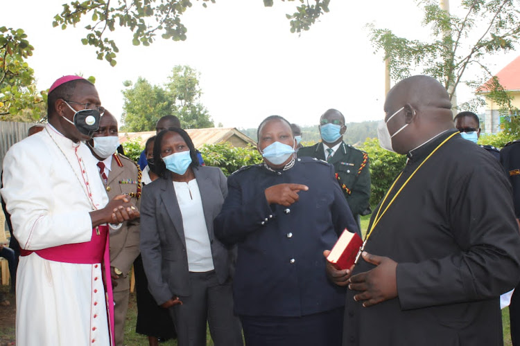 Bishop Alfred Rotich with top security officers from Bomet led by county police commander Naomi Ichami (second right) during a service at St Michael catholic church on Saturday.