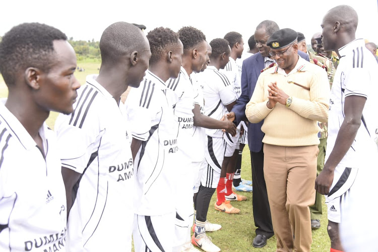 Nakuru County Commissioner greets Kalyet Football Club players at Tuiyotich Village in Njoro, Nakuru County.