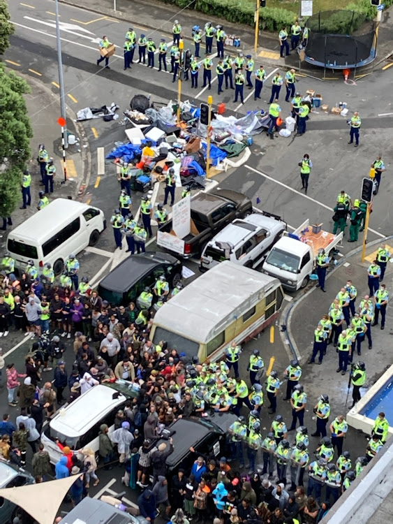 Police officers confront anti-coronavirus disease (Covid-19) vaccine mandate protesters outside the Parliament buildings in Wellington, New Zealand, March 2, 2022.