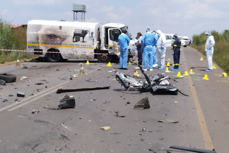 Police at the scene after a cash delivery vehicle was attacked on the R42 in Delmas, Mpumalanga, on Monday. Two suspected robbers were killed and two arrested after the attack.