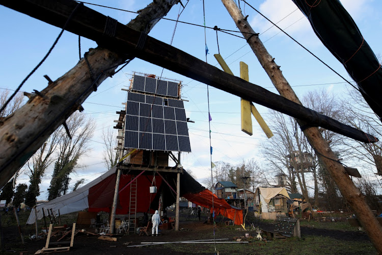 Makeshift houses with solar panels at Luetzerath, a village about to be demolished for the expansion of the Garzweiler open-cast lignite mine. THILO SCHMUELGEN/REUTERS