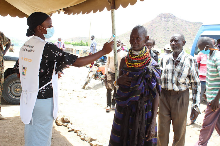 Health worker Leylac Minayo screens travellers on the Lodwar-Kakuma route