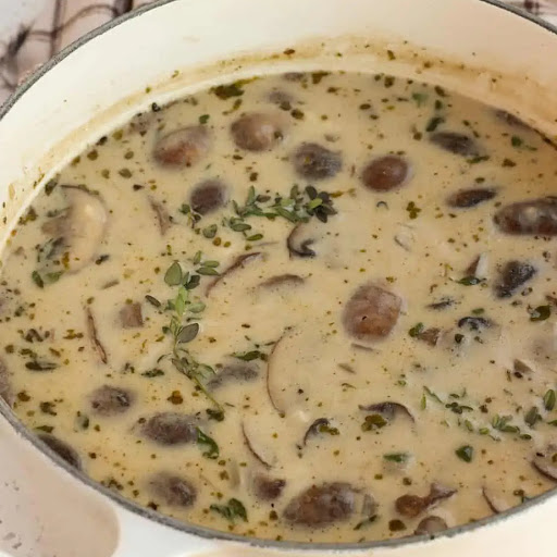 A rich and Creamy Mushroom Soup Recipe with sweet onions, cremini mushrooms, and garlic in a lightly seasoned chicken broth with marjoram and thyme.