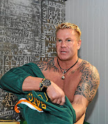 Marc Batchelor putting on a personalised Bok jersey during a  supporters club event at the East Rand Mall in  2010. /  Duif du Toit / Gallo Images.