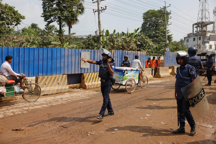 Security forces remain vigilant in front of the garment factories, following clashes between garment industry workers and police over pay, at the Ashulia area, outskirts of Dhaka, Bangladesh, on November 8 2023. Picture: MOHAMMAD PONIR HOSSAIN/REUTERS