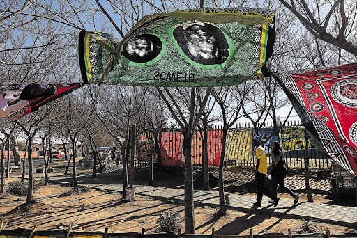 HIGH SPIRITS: Trees outside the Hector Pietersen memorial near former president Nelson Mandela's old home in Vilakazi Street, Orlando West, Soweto, were yesterday decorated with traditional gear in celebration of his life. FIle photo