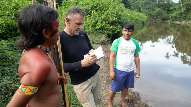 Dom Phillips talking to two indigenous men in Roraima State, Brazil in 2019.