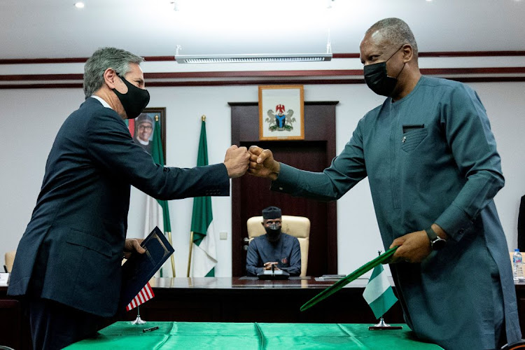 Nigerian Vice-President Yemi Osinbajo, watches as US secretary of state Antony Blinken fist bumps with Nigerian foreign minister Geoffrey Onyeama at the Aso Rock Presidential Villa in Abuja, Nigeria, November 18 2021. Picture: ANDREW HAMIK/REUTERS