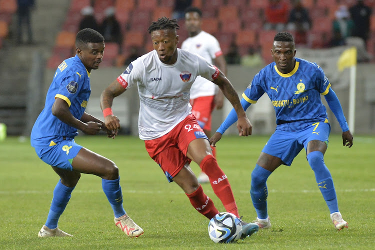 Chippa United midfielder Ayabulela Konqobe challenged by Teboho Mokoena and Lesiba Nku Mamelodi Sundowns during their DStv Premiership match at Nelson Mandela Bay Stadium in Gqeberha on August 19 2023.