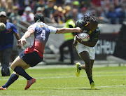 Seabelo Senatla of South Africa tackled by Sergei Ianiushkin of Russia during day 1 of the 2017 HSBC Cape Town Sevens match between South Africa and Russia at Cape Town Stadium on December 09, 2017 in Cape Town, South Africa. 