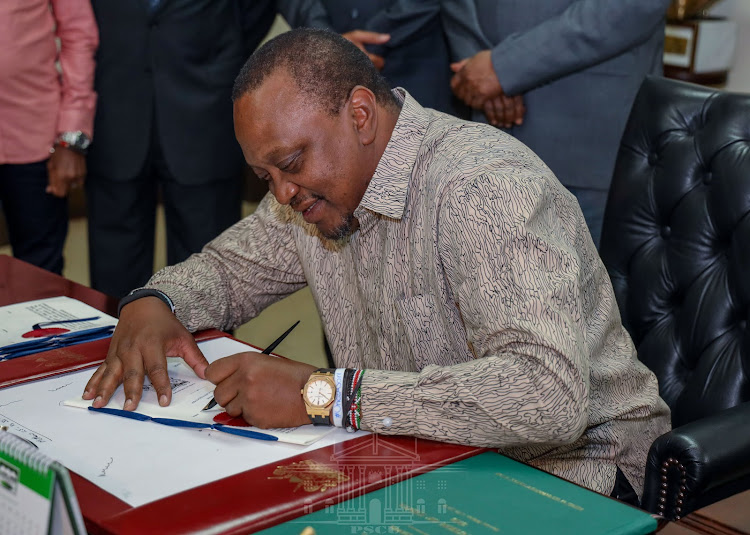 President Uhuru Kenyatta signing the Data Protection Bill into law.