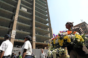 Gauteng MEC for health Bandile Masuku lays a wreath commemorating the three firefighters who died at the Bank of Lisbon building in the Johannesburg CBD last year. /THULANI MBELE