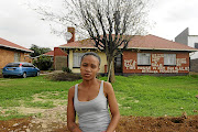 Wandile Makoko, 21,  in front of her family home in Power Park, Soweto, which was allegedly sold by her uncle without the family's consent. /Thulani Mbele