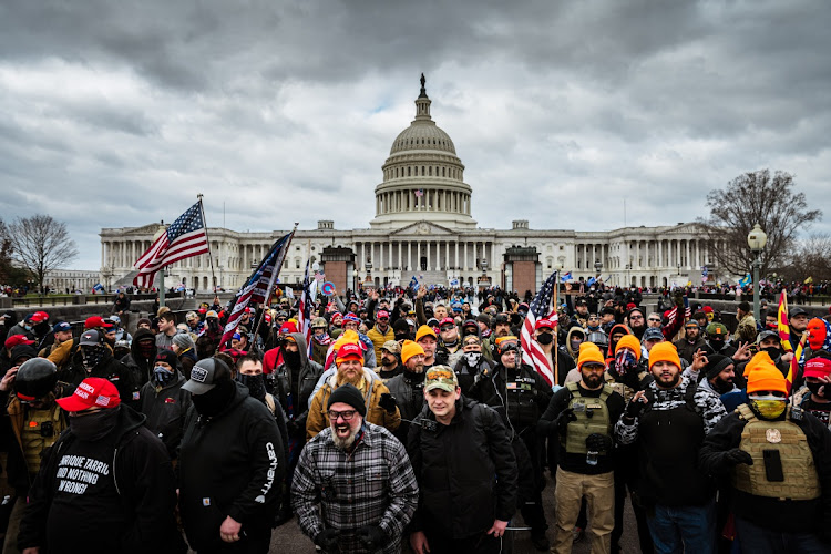 Supporters of former US president Donald Trump gather outside the US Capitol in Washington DC on January 6 in protest at the ratification of president-elect Joe Biden's electoral college victory over Trump in the 2020 election. A mob stormed the Capitol building shortly afterwards, breaking windows and clashing with police officers.