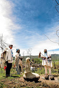 Dyalvane and his family prepare to install  'uMalusi (Shepherd)' on the hilltop opposite Ngobozana where it will serve as a monument offering healing to those who have been dispossessed.