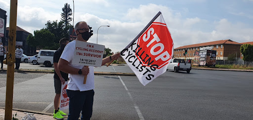 Darryl Mendes, who suffered a traumatic brain injury four years ago in a cycling accident, joins the silent protest at the Kempton Park magistrate's court.